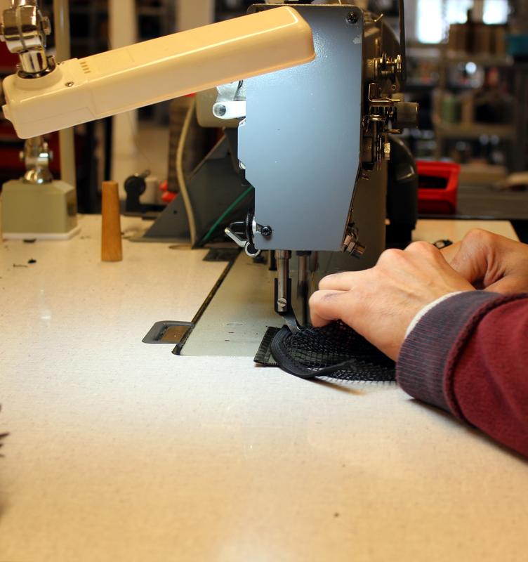Closer to a sewing machine producing tactical equipment