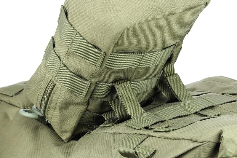 The webbing of the pouch is pulled through the second loops on the backpack.